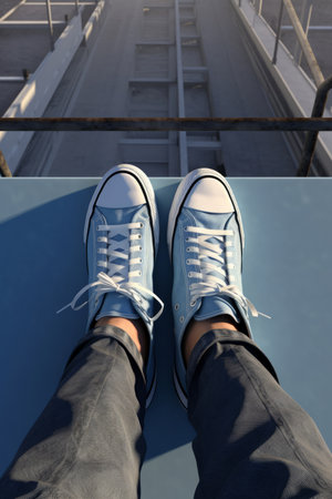 Selfie of legs in sneakers on the roof of a cruise shipの素材