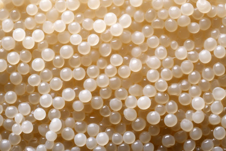 close up of a group of white pearl beads as a background textureの素材