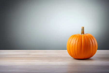 Pumpkin on wooden table and gray background. Halloween concept. Empty space for textの素材