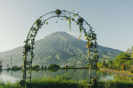 Wedding arch on the lake with mountain background in morning time.の写真素材