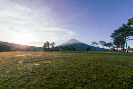 The view when the sun appears on a beautiful mountain meadow is enchanting, located on the island of Java, Indonesiaの写真素材