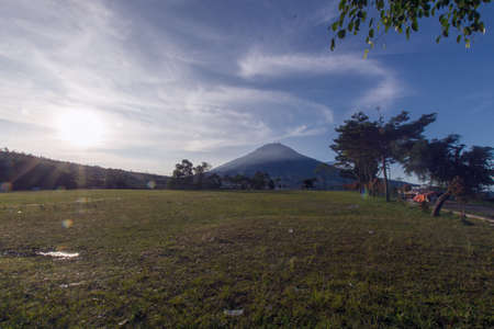 The view when the sun appears on a beautiful mountain meadow is enchanting, located on the island of Java, Indonesiaの写真素材