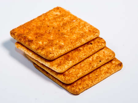 Stack of crackers isolated on white background. Crispy biscuits.の写真素材