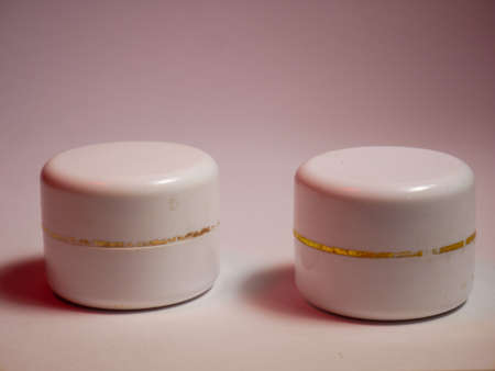 two white cosmetic containers for cream, gel, shampoo, lotionの写真素材