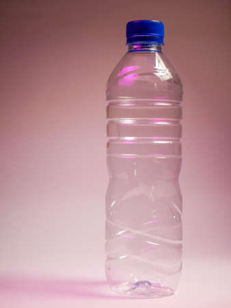 Plastic bottle with water on a pink background. Close-up.の写真素材