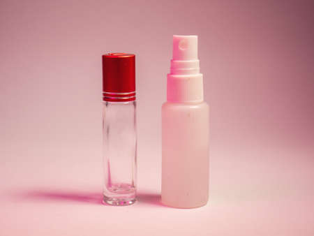 Spray bottle with red cap on a pink background. Cosmetic productの写真素材