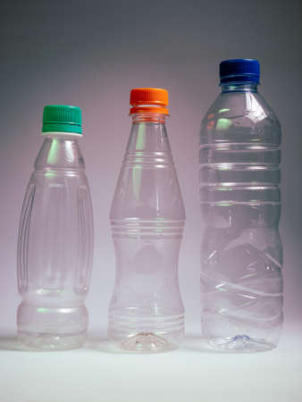 Plastic bottles of water on a gray background. Plastic bottles for drinking water.の写真素材