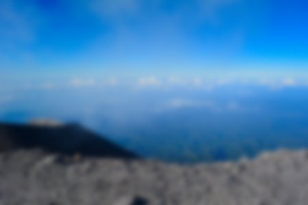 Blurred landscape blue sky with clouds, beautiful fantasy pastel colorful landscape background, gradient sky, sunrise with mountains in distantの写真素材