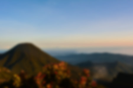Blurred landscape blue sky with clouds, beautiful fantasy pastel colorful landscape background, gradient sky, sunrise with mountains in distantの写真素材