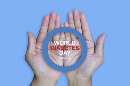Top view inscription world diabetes day and hand gesture with red blood drop in man hands isolated on a blue background. World diabetes day, 14 november. Copy space., Health Awarenの写真素材