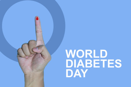Top view inscription world diabetes day and hand gesture with red blood drop in man hands isolated on a blue background. World diabetes day, 14 november. Copy space., Health Awarenの写真素材