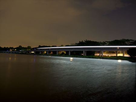 A moving train that leaves light reflection on Lower Seletar Reservoirの写真素材