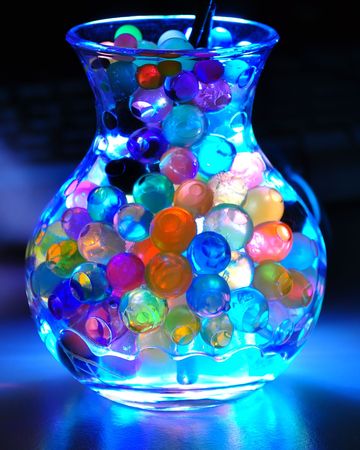 Illuminated jar with many colourful pearls insideの写真素材