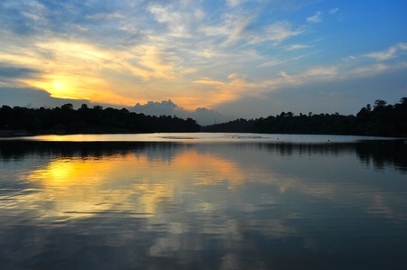 Sky, filled with sunset and clouds, with their clear reflections on Matrichie Reservoir (Singapore)の写真素材