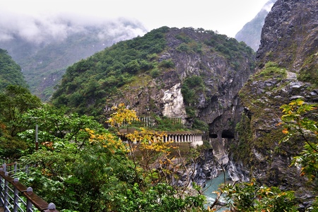 Scenic Taroko gorge with a tunnel, and greeneries in the foregroundの写真素材