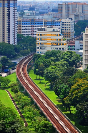 Train railings surrounded by greenery, office and residential buildings at Kallang area, Singaporeの写真素材