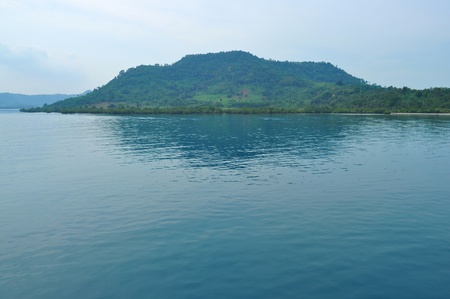 A hill by the sea with its reflection at Sumatra Island 