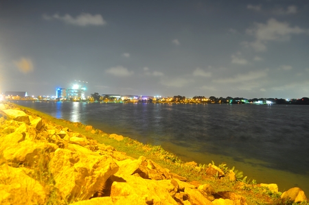 Lower seletar reservoir near Yishun Dam, north of Singapore with rocks on its edge at nightの写真素材