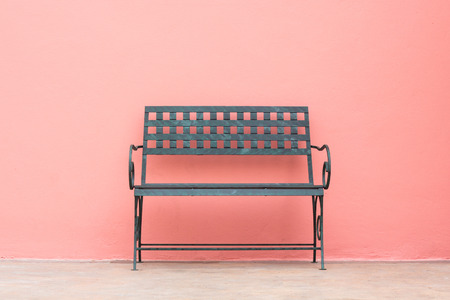 iron chair in front of wall