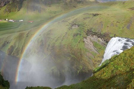 Rainbow above waterfall Sk?gafoss on South Icelandの写真素材
