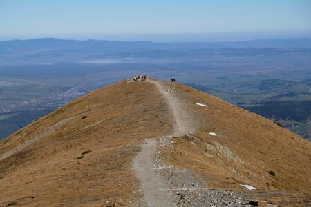 Silhouette of tourists on Ciemniak Peak, Western Tatras, Czerwone Wierchy. The Western Tatras are...