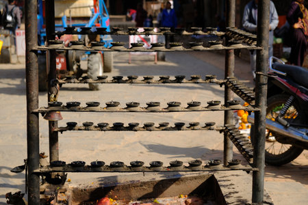 Bhaktapur, Nepal - circa November 2019: Stand with burned candles standing on the street. Bhaktapur, Kathmandu Valley, Nepal, Asiaのeditorial素材