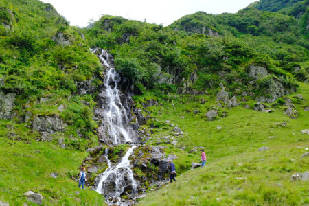 CASCADA CAPRA WATERFALL, FAGARAS MOUNTAINS, ROMANIA - circa July 2018: The people at Cascada Capra Waterfall in Fagaras Mountains, Romanian Carpathiansのeditorial素材