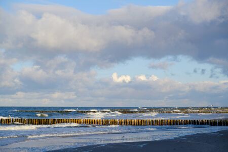 Breakwaters on sea coast in sun light. Baltic Sea, Dziwnowek, Poland