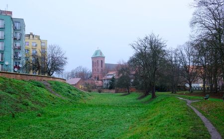 Former moat and Co-Cathedral of St. John the Baptist in background in Kamien Pomorski, Poland