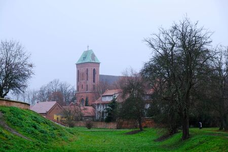 Former moat and Co-Cathedral of St. John the Baptist in background in Kamien Pomorski, Polandの写真素材