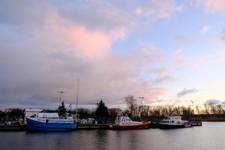 Dziwnow, Poland - circe November 2019: Boats in port of Dziwnow coastal village over Baltic Sea in evening lightのeditorial素材