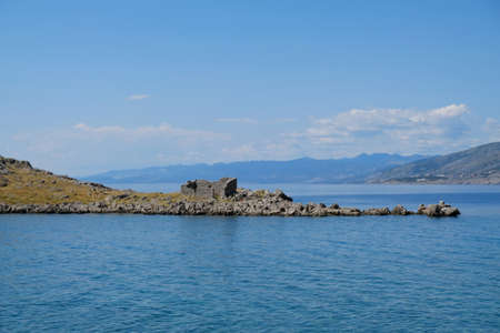 Rocky island with ruins in Sveti Juraj, Croatia. A small quiet port village on the Adriatic with crystal clear water.の写真素材