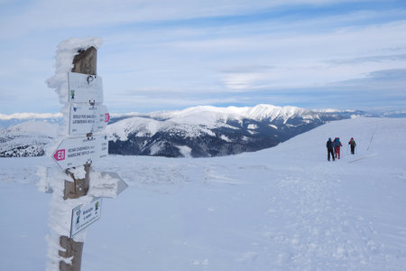 Low Tatras - circa February: Beautiful winter mountain views during a snowshoe hike along the red ridge trail in the - tourist singpost at Kosarisko Peak and silhouettes of touristsのeditorial素材