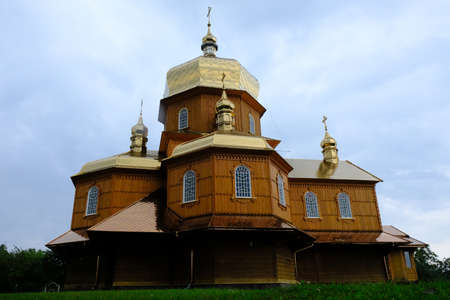 Tserkva Vozdvyzhennya Chesnoho Khresta - wooden orthodox church with golden roof in Semyhyniv,...