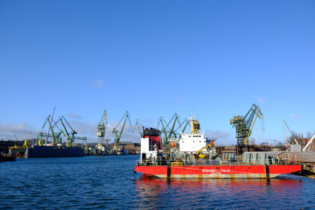 Gdansk, Poland - circa March 2020: View of shipyard areas with ships and shipbuilding cranes