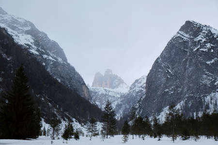Tre Cime di Lavaredo in winter misty scenery, seen from the famous viewpoint situated near Lago di...