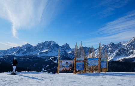 Sexten Dolomites, Italy - circa February 2020: Silhouette of woman skier standing on slope of Monte Elmo / Helm peak. South Tirol, Sexten Dolomites, Italyのeditorial素材