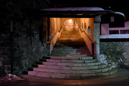 Sexten, Italy - circa February 2020: Stairs next to church by night in Sexten (Sesto) in Dolomites in Italyのeditorial素材