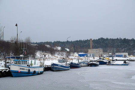 Swibno, Gdansk, Poland - circa January 2021 - Old fishing port with boats in winter scenery.のeditorial素材