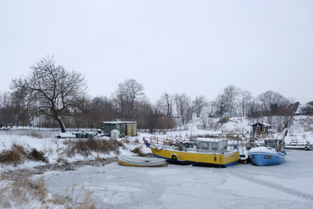 Swibno, Gdansk, Poland - circa January 2021 - Old fishing port with boats in winter scenery.のeditorial素材