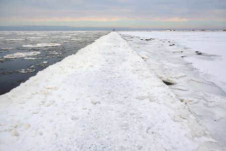 Vistula estuary and concrete breakwater in Mikoszewo in winter scenery. Shuga - ice floe in shape of...