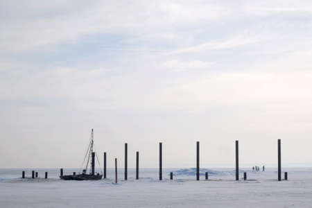 A frozen sea with piles of destroyed pier and boat in morning light. Rzucewo, Puck Bay, Baltic Sea, Polandの写真素材