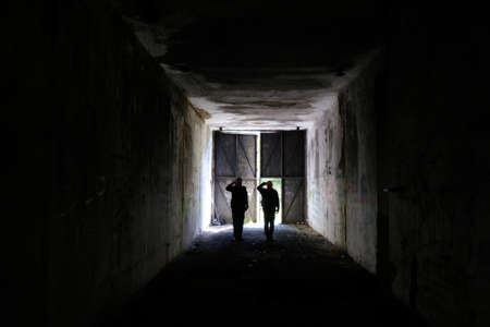 Gostomie, Poland: June 13, 2021: Two men saluting in a bunker in a former military unit on Lysa Gora...