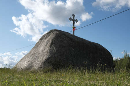 Devil's Stone with a cross in the village OwÅnice, Kashubia, Polandの写真素材