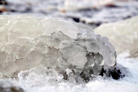 Beautiful natural phenomenon - ice covered stones on the coast at the Vistula mouth to the Baltic, Sobieszewska Island, Polandの写真素材