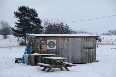 Mikoszewo, Poland - circa February 2021: Wooden hut with fishing equipment. There are fishing nets, buoy, lifebuoy and life vest on the wall. The mouth of the Vistula.のeditorial素材