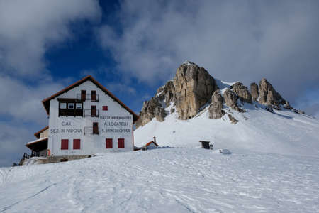 Tre Cime, Dolomites, Italy - circa February 2020 - Beautiful panorama of Tre Cime di Lavaredo and Monte Paterno in sunny winter scenery. Locatelli hut and chapel at foot of mountains. Dolomites, Italyのeditorial素材