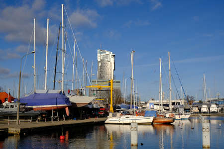 A lot of yachts standing in yacht port in Gdynia, Poland. Sea Towers in background.の写真素材
