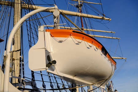 Close-up on a lifeboat hunging on a sailing ship