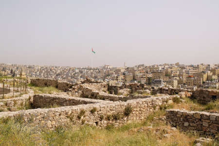 Ruins of Citadel Jebel Al Qala'a in Amman, Jordan. Panorama of Amman city with modern buildings in background.の写真素材